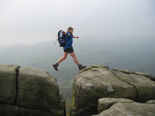 14_07-2.jpg - Steve, jumping, with Kinder Scout behind.